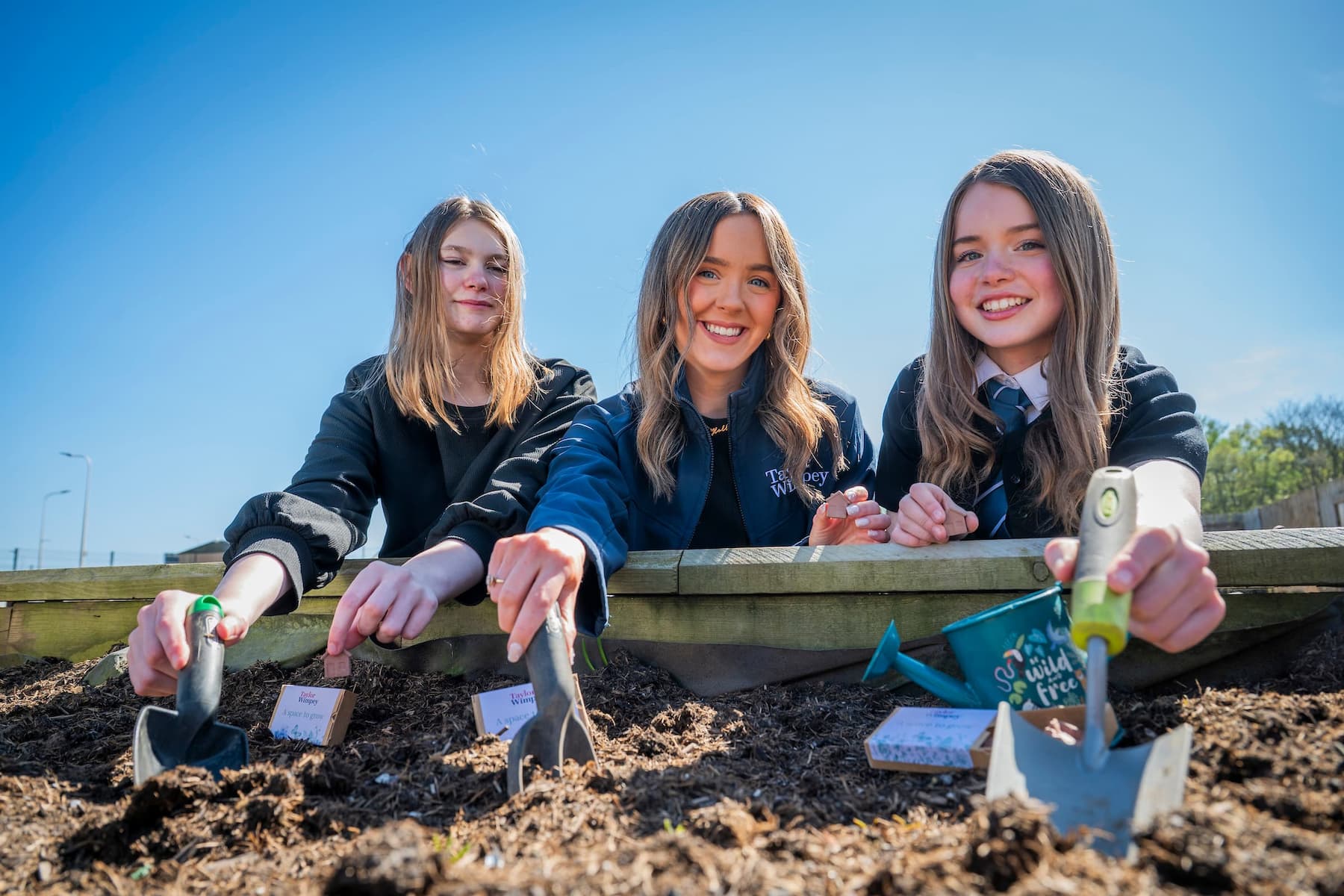 School kids and Taylor Wimpey staff planting