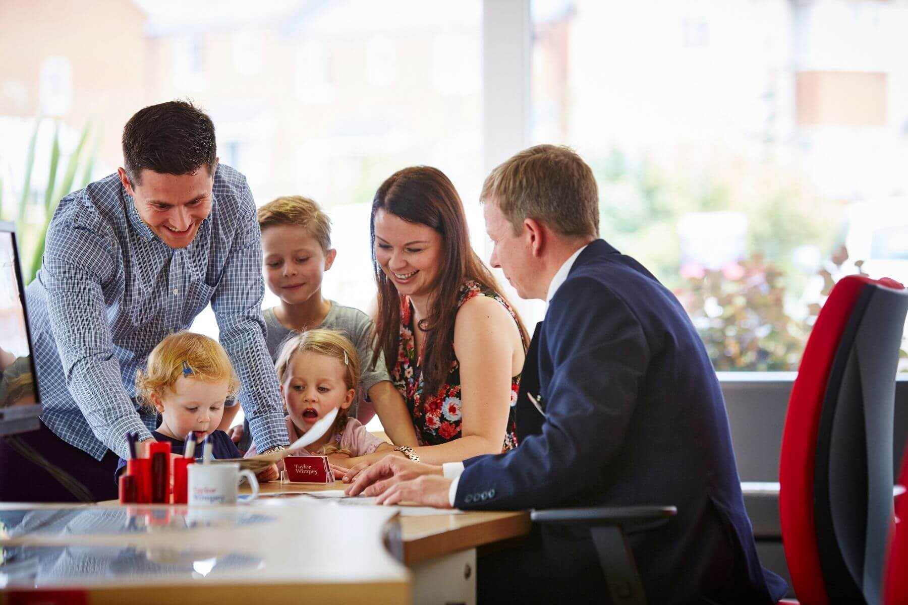 Taylor Wimpey Sales Executive with customers