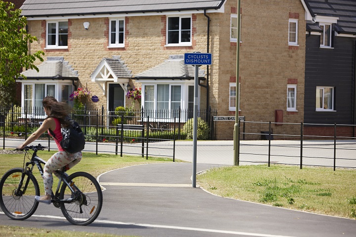 Cyclist outside Taylor Wimpey development