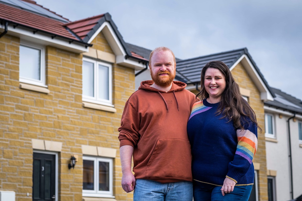 New homeowners outside front of home