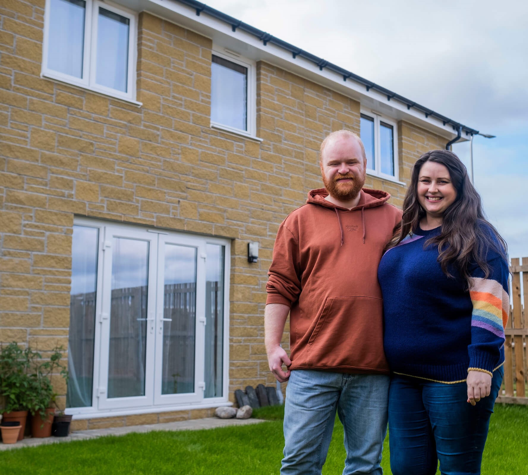 New homeowners stood in garden