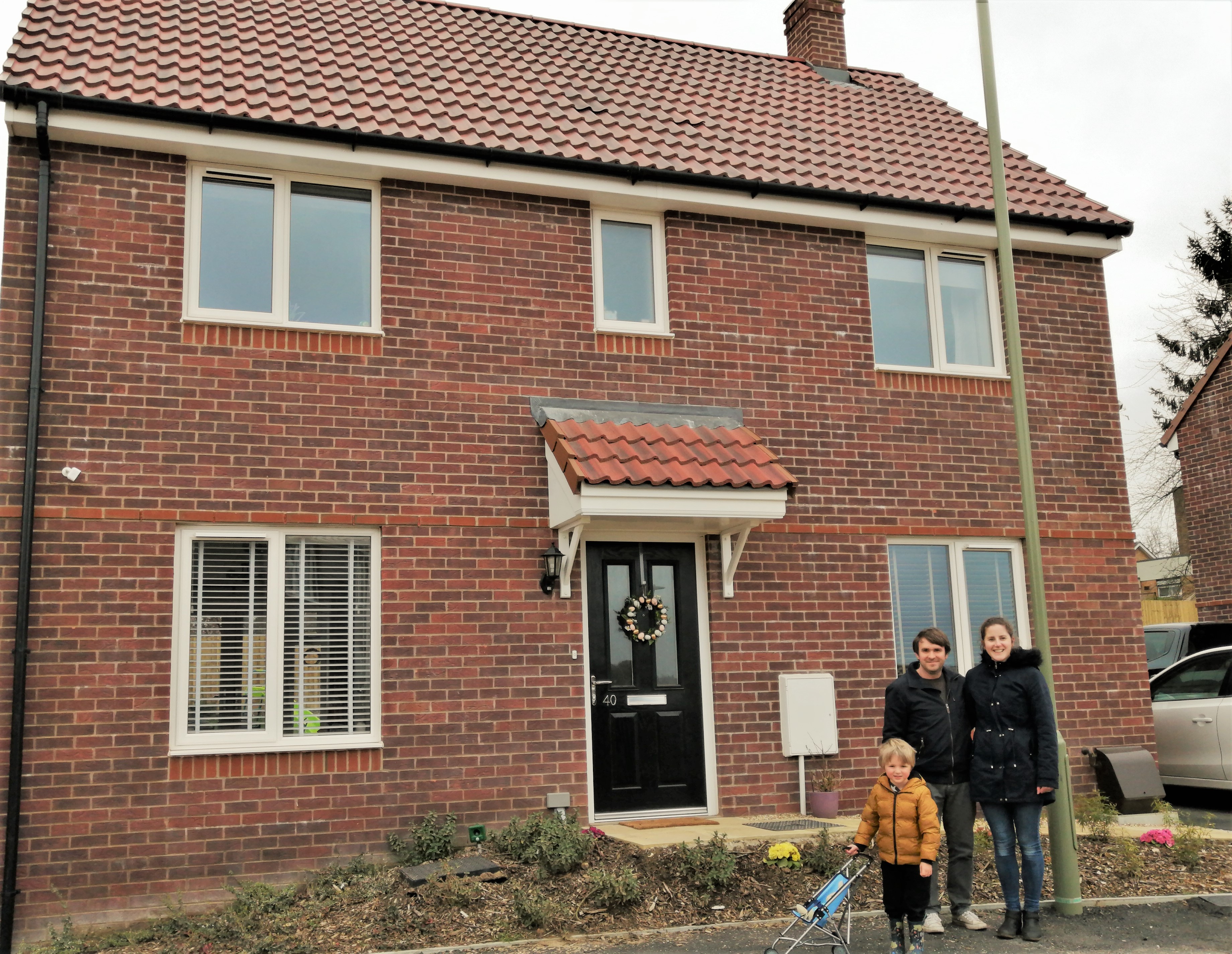 Family outside new 3 bed home
