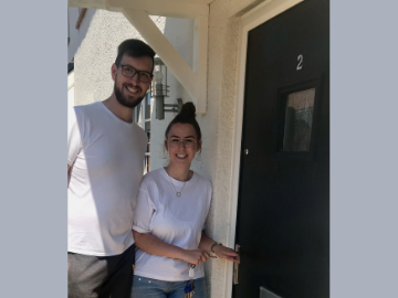 Couple outside new home