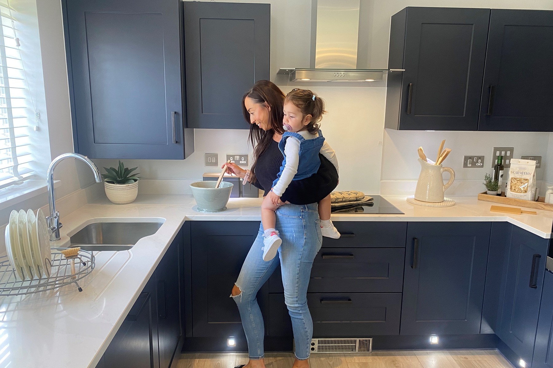Olivia and her daughter in their new kitchen