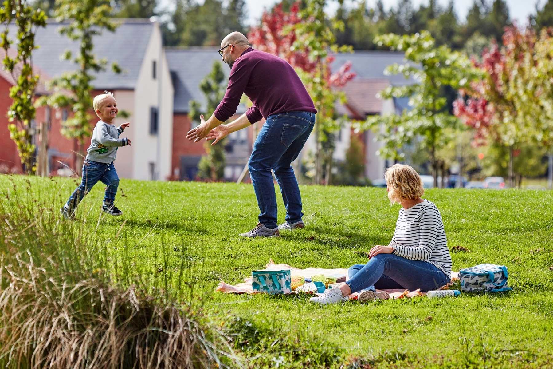 young family playing games in community park