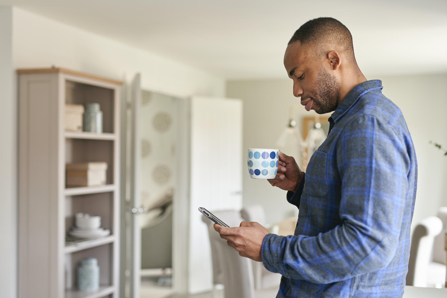 Man with phone and coffee