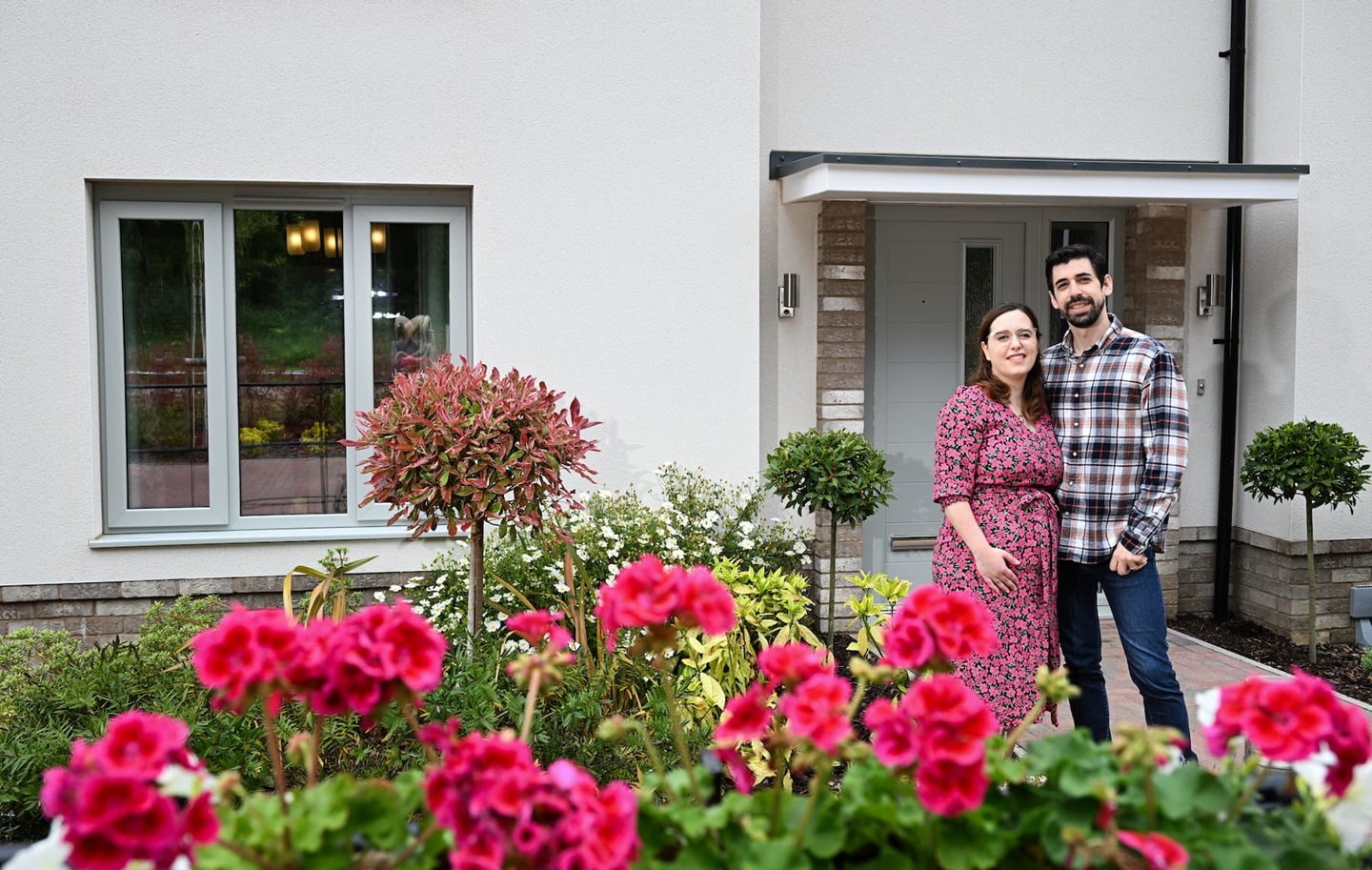Couple stood in front of their home.