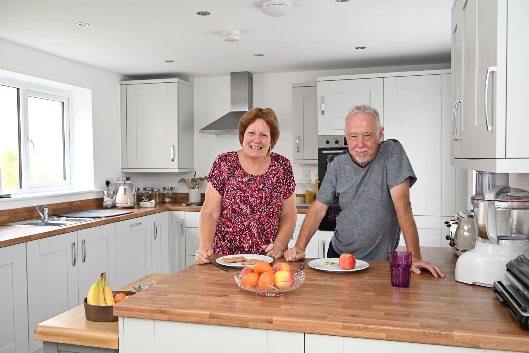 Couple standing in kitchen