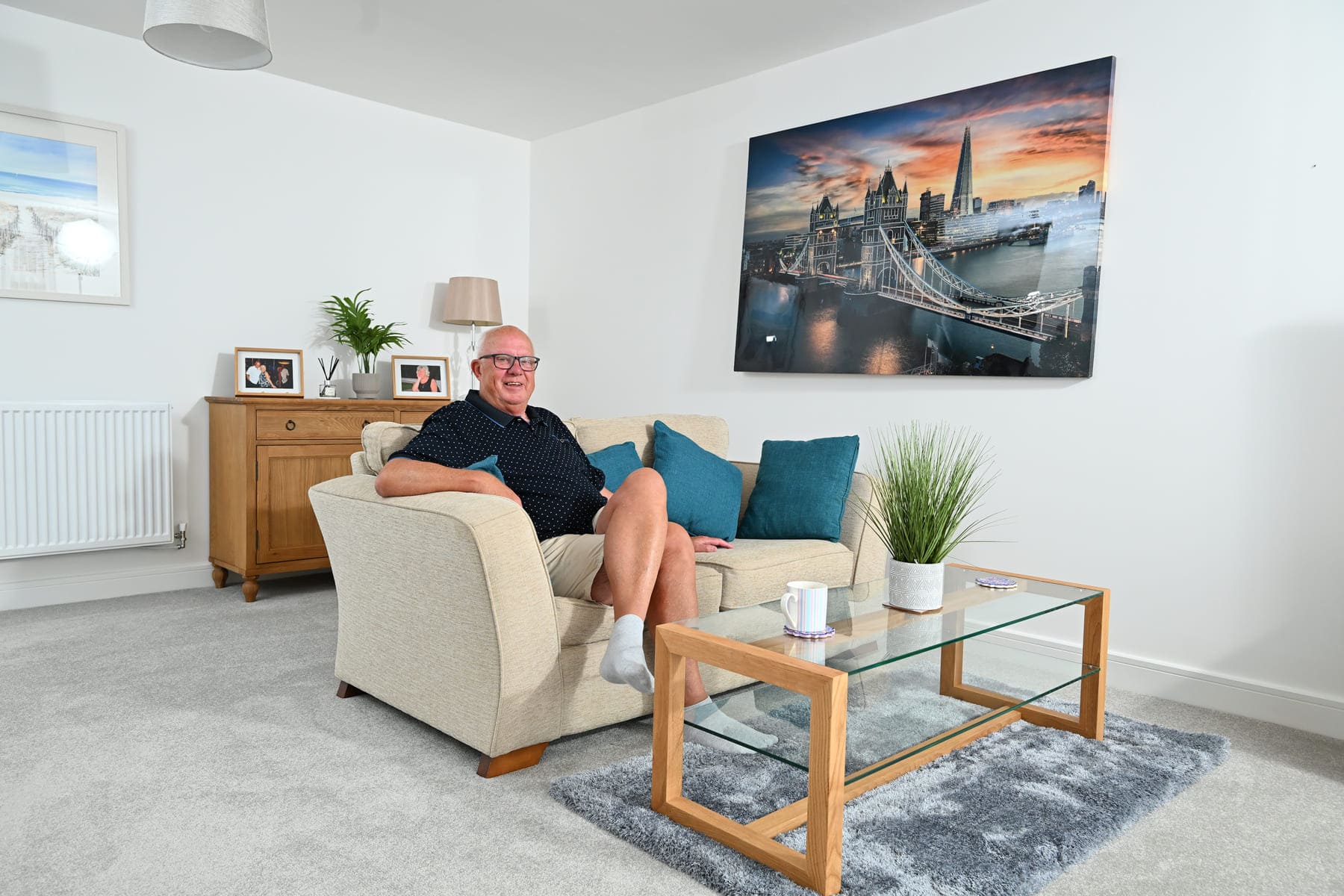 Man sat on a sofa in lounge