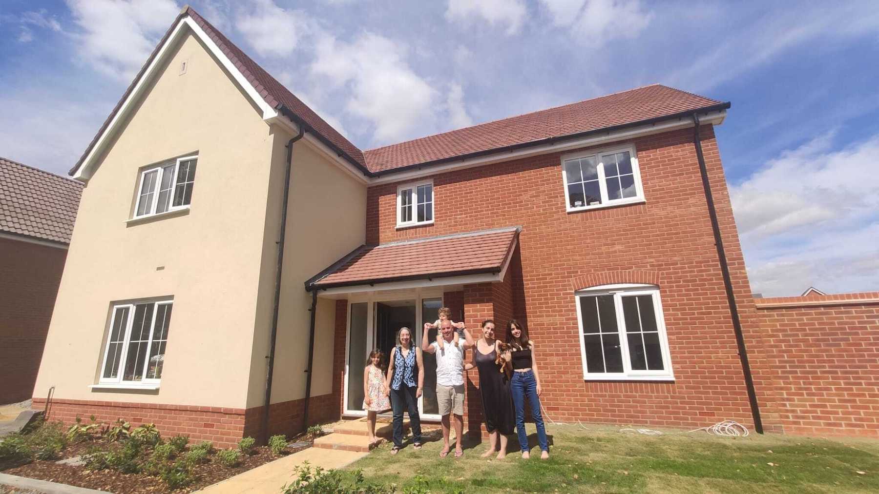Happy residents outside house