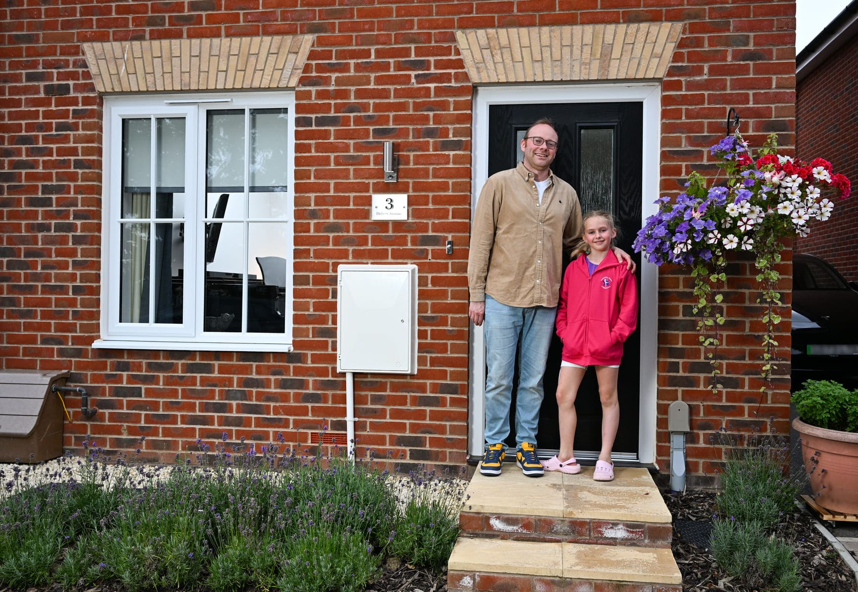 Dad and daughter outside house