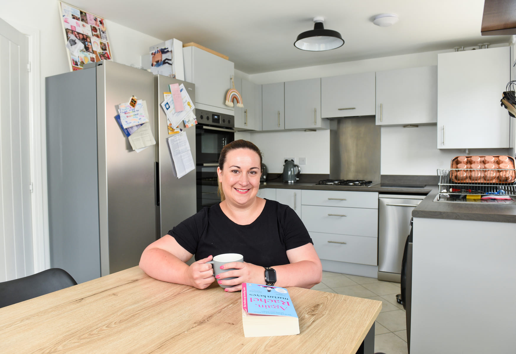 Customer in kitchen with cup of tea