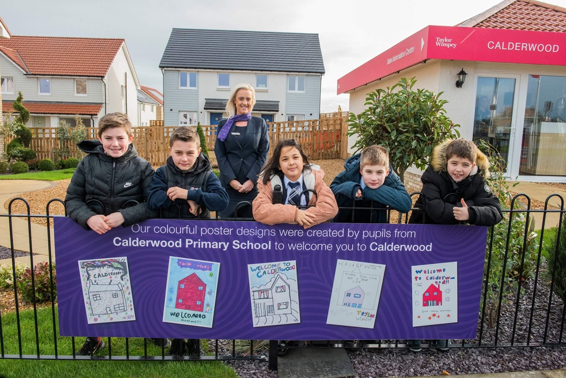Calderwood primary school pupils and sales executive from Calderwood with banner