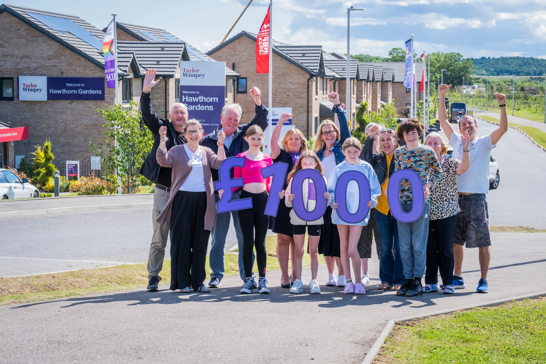 Representatives from Queensferry Community Association, City of Edinburgh Council Lifelong Learning Services, Queensferry & District Community Council join local Taylor Wimpey East Scotland sales executive Helen Allenby at Hawthorn Gardens in South Queensferry.  They are also joined by some of the young people hoping to take part in the Summer Fun Programme.