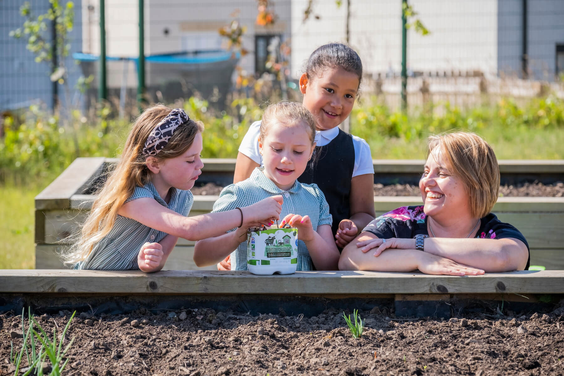 Karen Malt, Taylor Wimpey East Scotland’s local sustainability champion with Melissa Shaw, Buglife Conservation Officer and children from Letham Mains Primary School