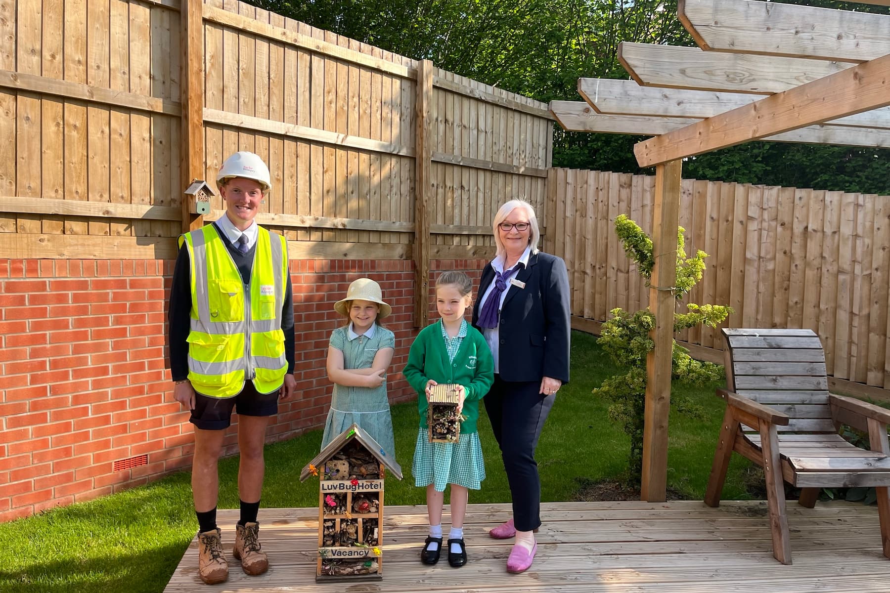 Taylor Wimpey staff and pupils of Willowbank Primary with the Bug Hotels
