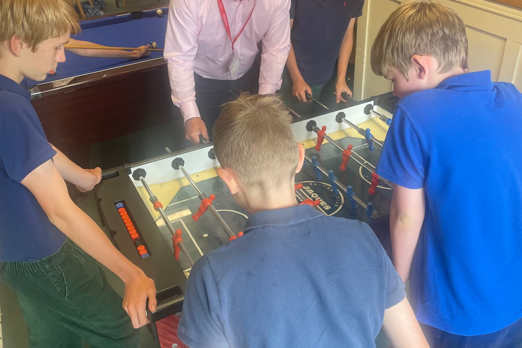 Children playing table football with our production director