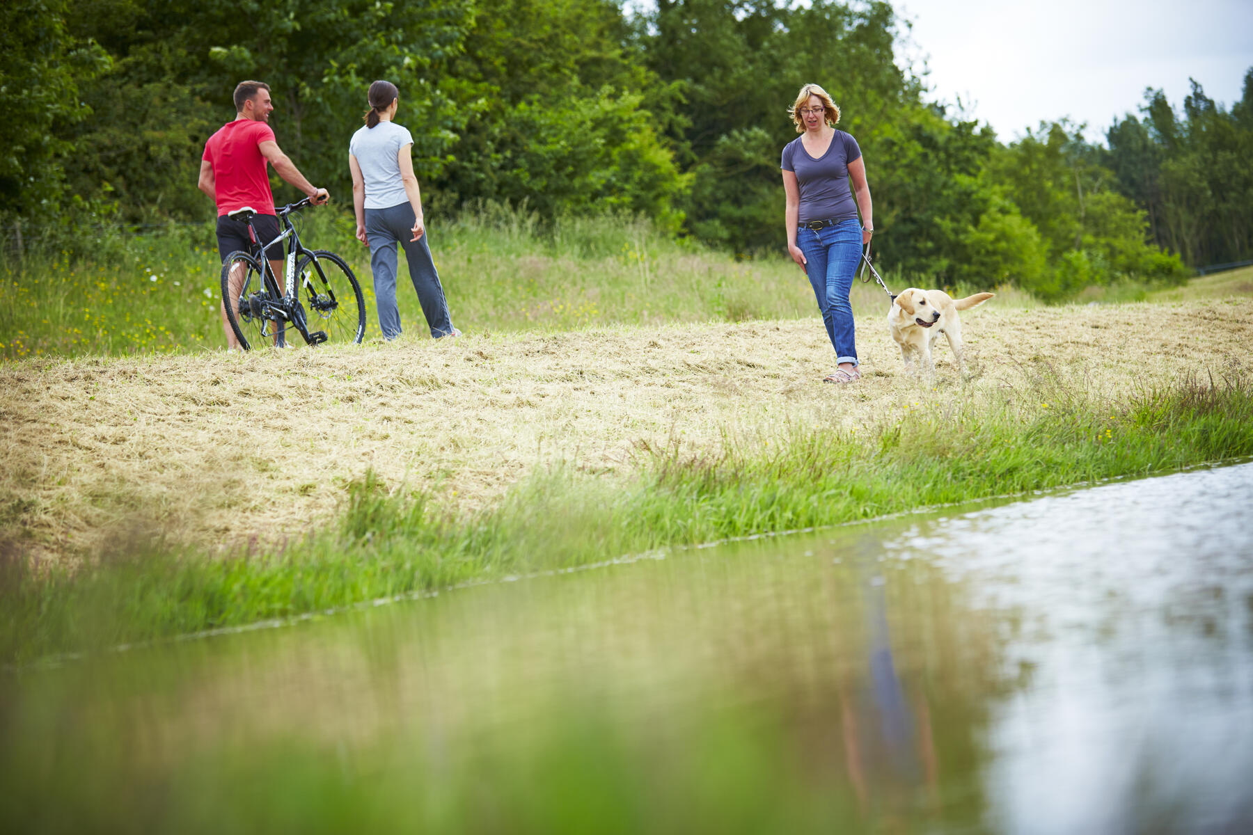 People walking by a river