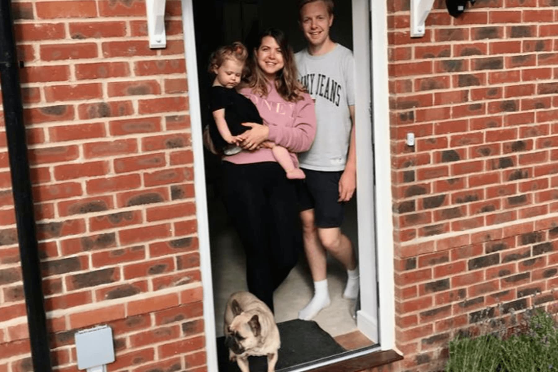 Family in hallway of new home