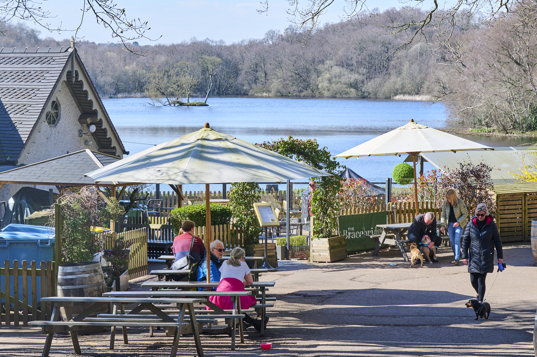 People outside a restaurant near a lake at Sutton Park