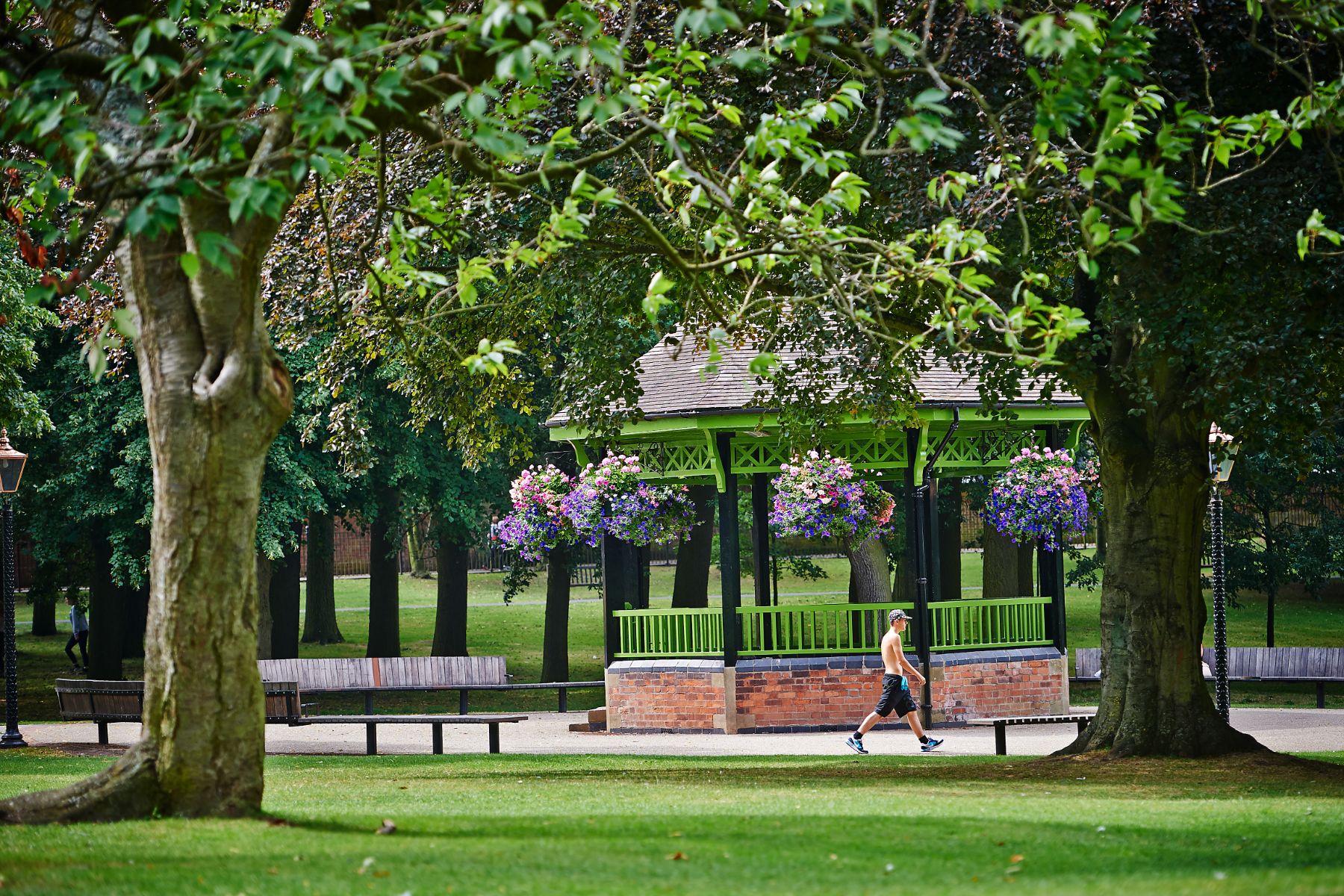 Park with trees, flowers and a bench in Rugby