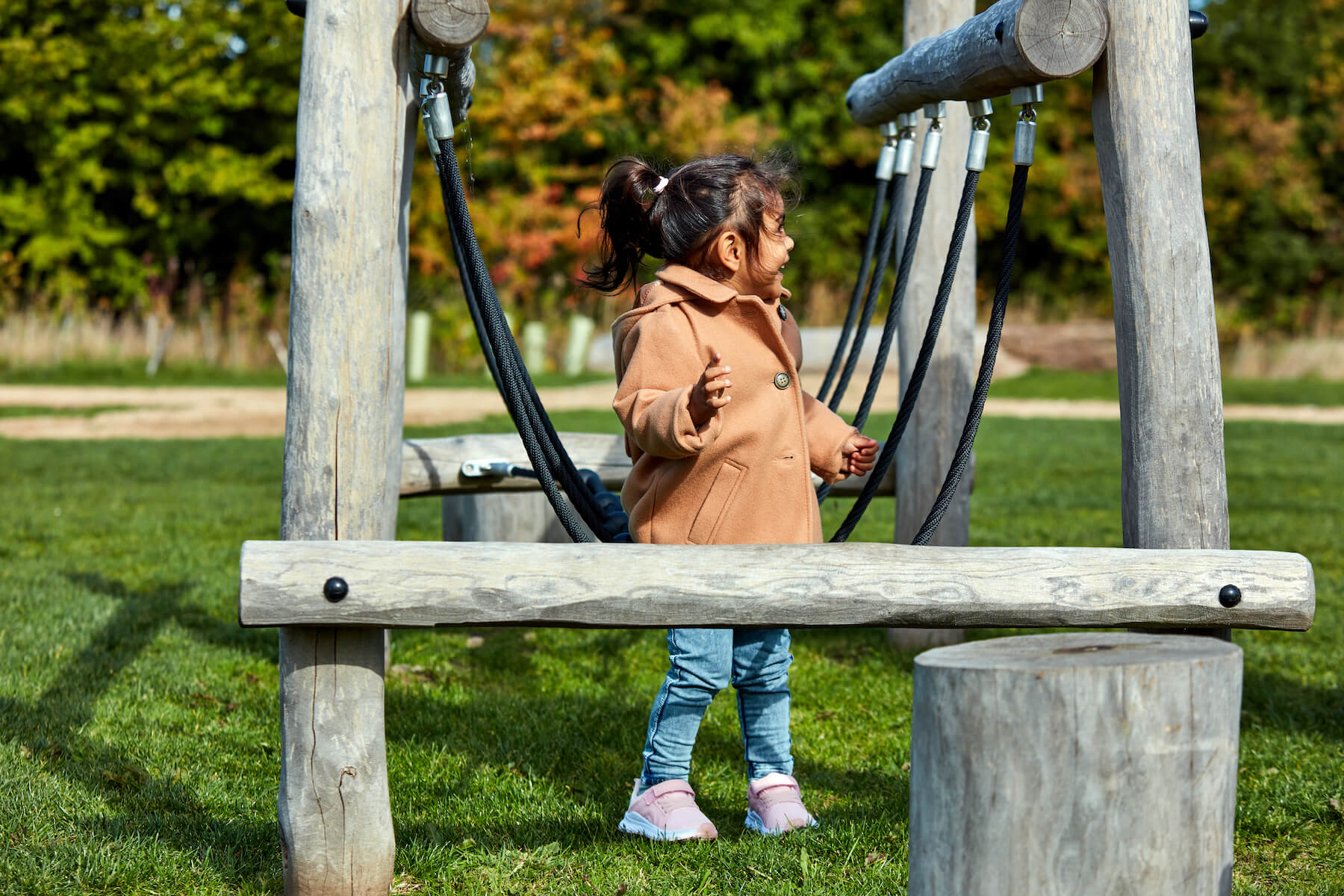 Girl playing on play equipment