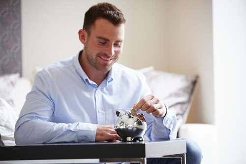 Man saving money in moneybox