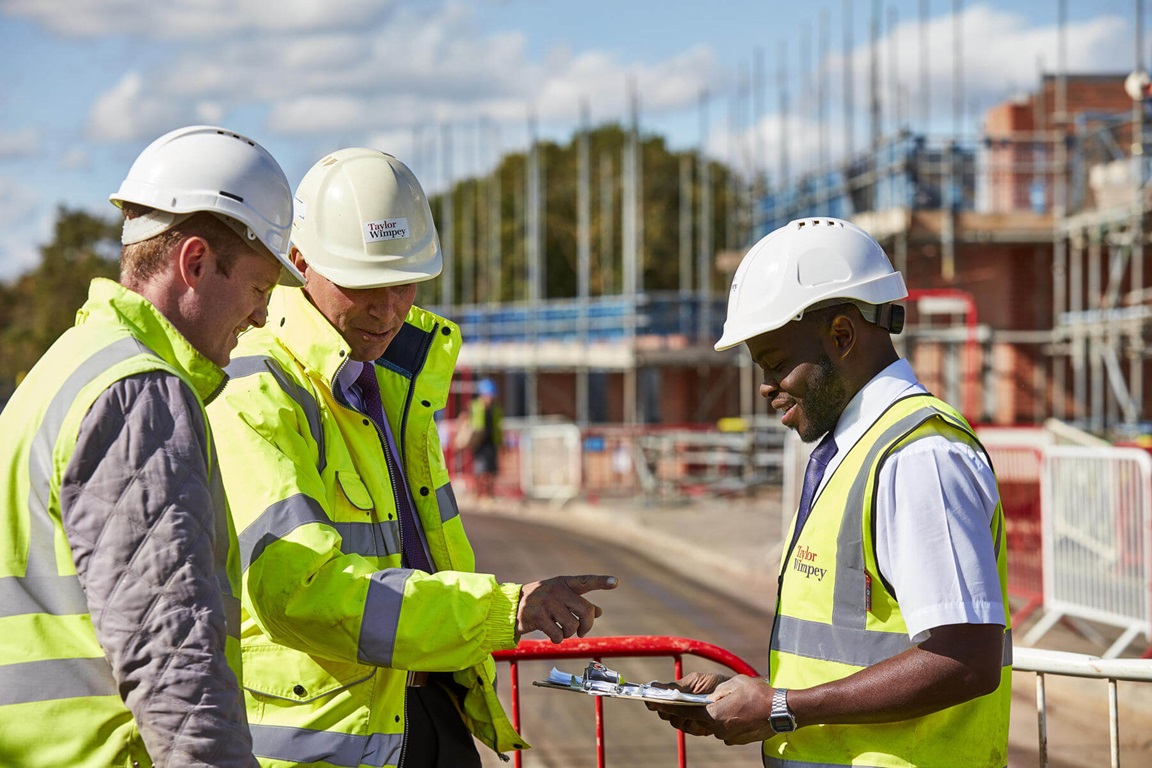 Site Managers with a clipboard on a development
