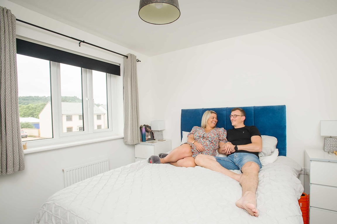 Couple relaxing on bed in new home