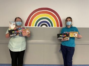 Nurses next to painted rainbow