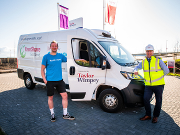 Van, Taylor Wimpey flags and two workmen