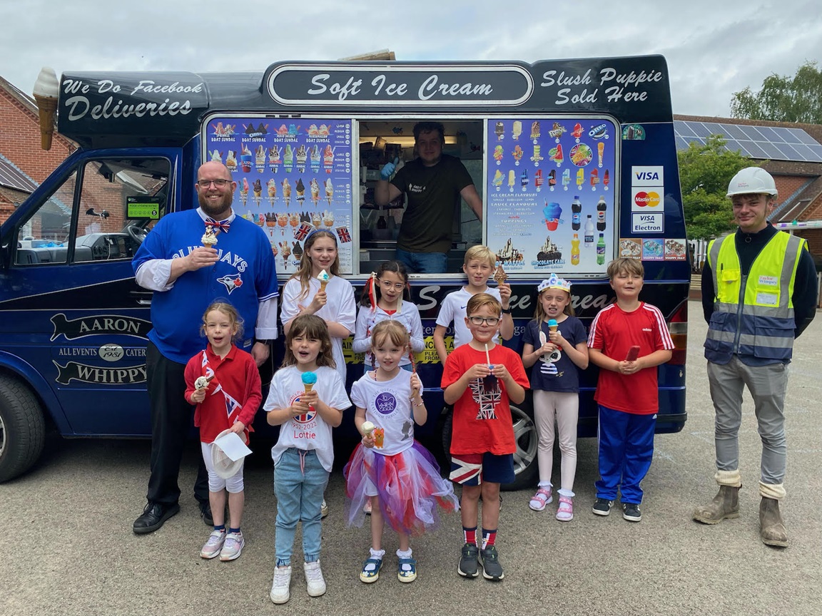 Children, teacher and Taylor Wimpey representative with ice cream van