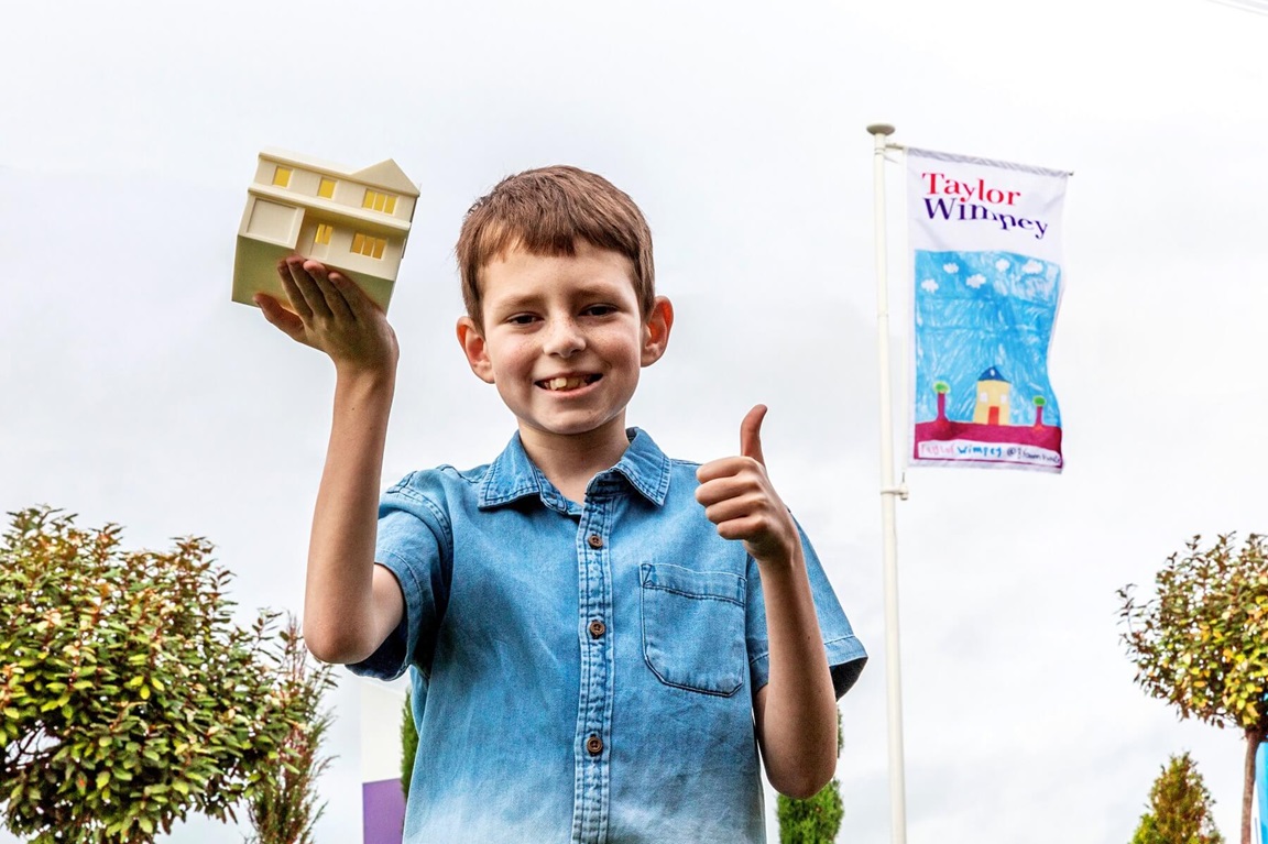Child in front of flag at Taylor Wimpey in Broomhouse, Glasgow