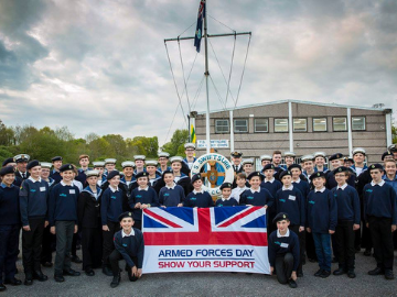 Farnham Sea Cadets stood infront of flag
