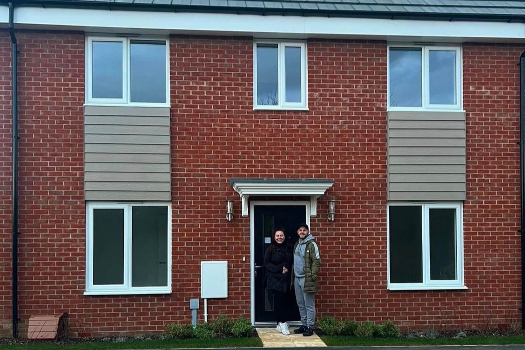 Isabella & Mitchel in front of their new home