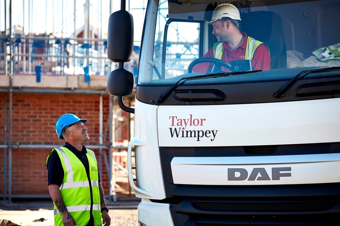 Site staff talking through truck window