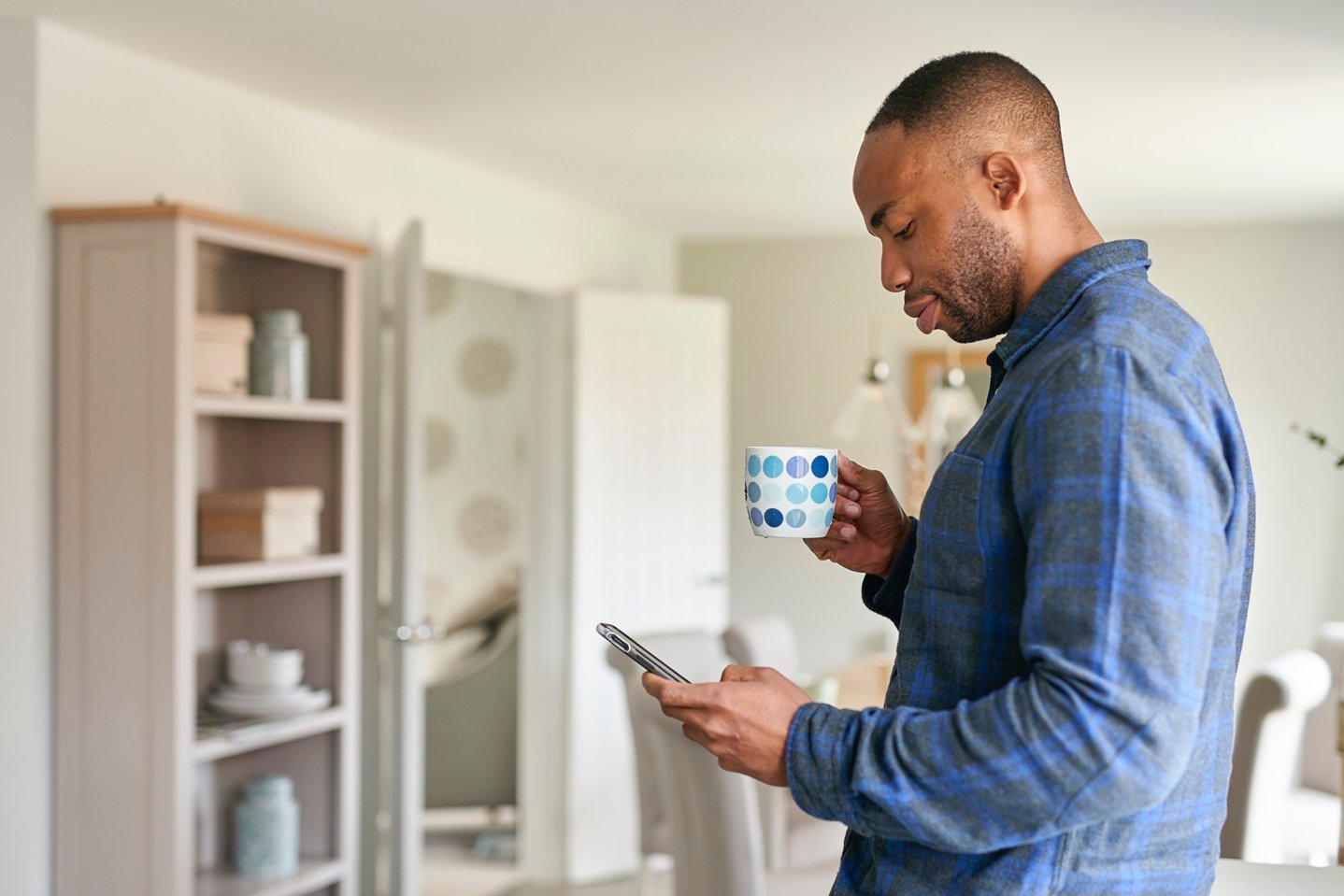 Man in new Taylor Wimpey kitchen on the phone