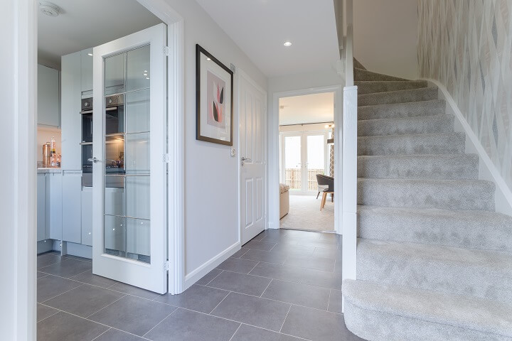 Grey hallway with grey carpeted stairs